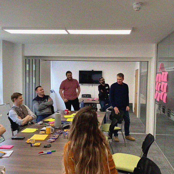A BOXT team workshop with pink sticky notes